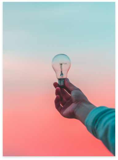 Hand holding light bulb
